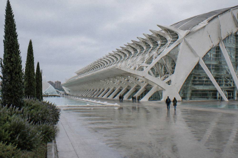 Ribbed white roof and glass facade of a large modern science museum building