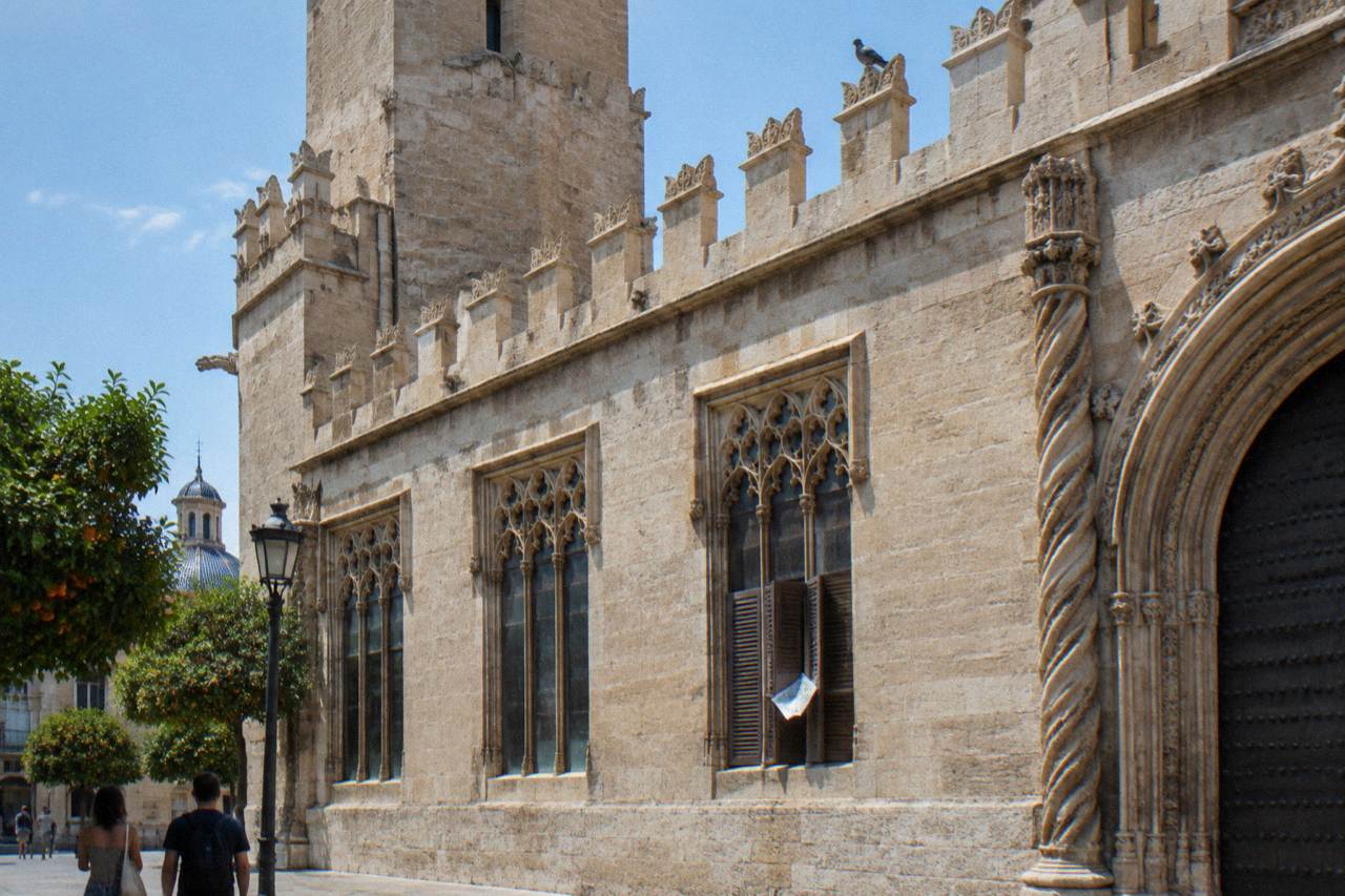 The Gothic towers and ornate stonework of the Lonja de la Seda in Valencia under a clear sky
