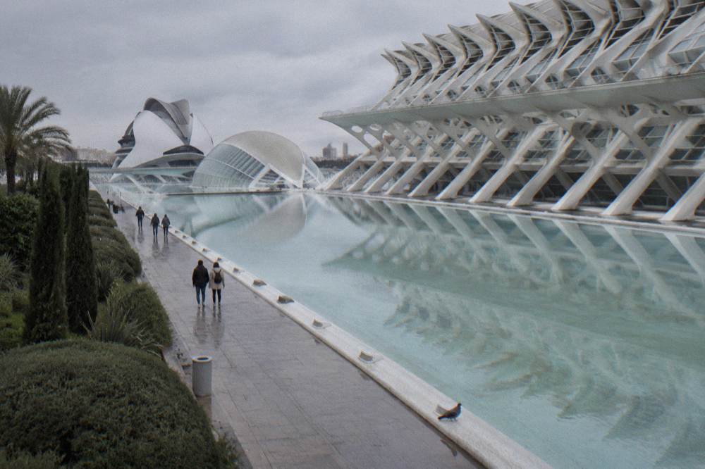 White futuristic buildings of a cultural complex reflected in shallow pools