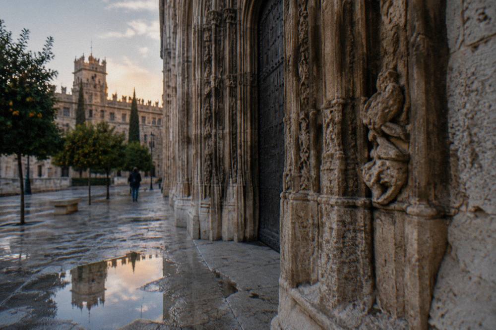 The ornate stone doorway of the Lonja de la Seda seen from the square