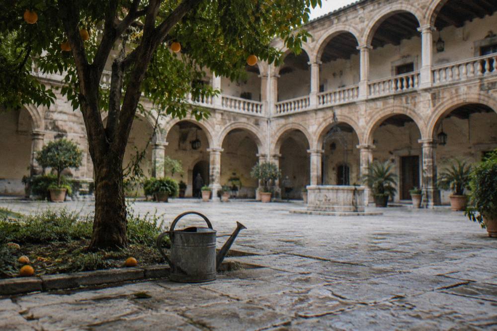 Cloister courtyard of a converted convent with arched walkways