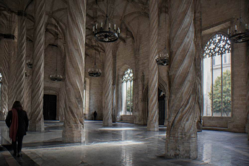 Gothic hall with twisted stone columns and a vaulted ceiling